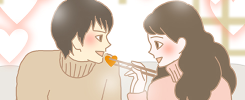 鍋のにんじんをあーんするカップル